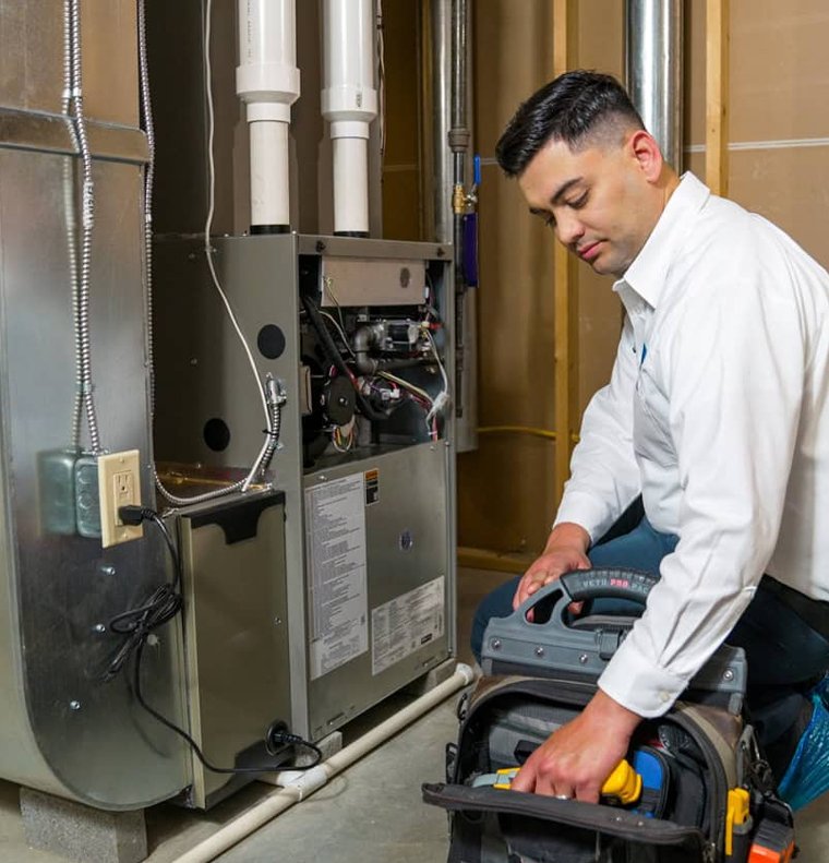 Professional HVAC technicians performing seasonal maintenance Professional HVAC technicians performing seasonal maintenance